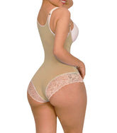 Woman wearing a beige shapewear garment with lace details on a white background